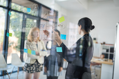 Buy stock photo Shot of businesswomen brainstorming in an office