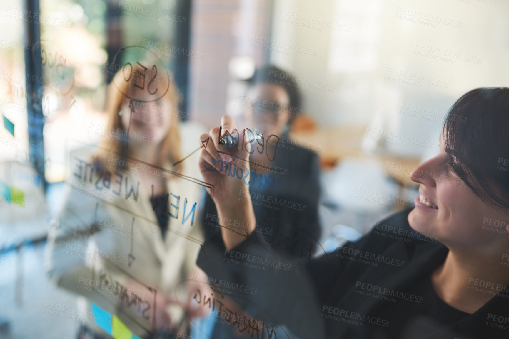 Buy stock photo Shot of businesswomen brainstorming in an office