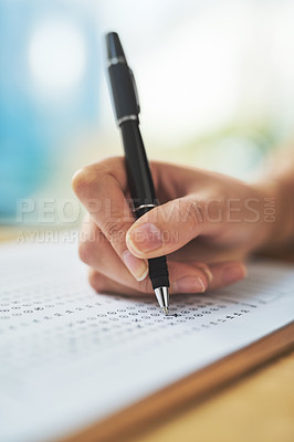 Buy stock photo Shot of a woman filling in an answer sheet for a test