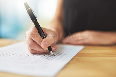Buy stock photo Shot of a woman filling in an answer sheet for a test