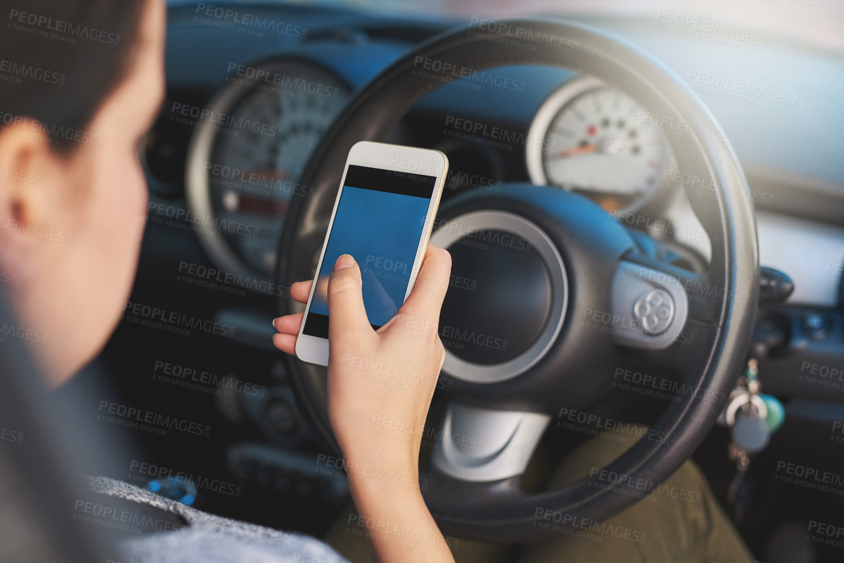Buy stock photo Shot of a woman using a phone while driving