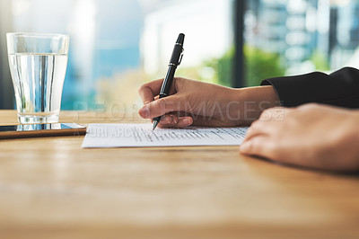 Buy stock photo Shot of a woman filling in some paperwork