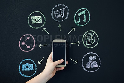 Buy stock photo Shot of a person holding a cellphone surrounded by icons