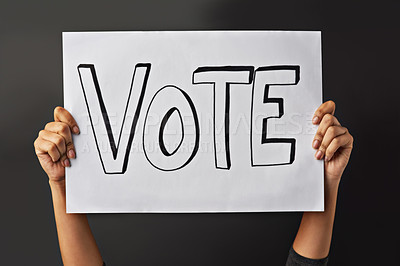 Buy stock photo Hands, poster and vote in studio for campaign on billboard, elections and ballot on black background. Fingers, person and activist for sign or unity on protest, placard and volunteer for choice
