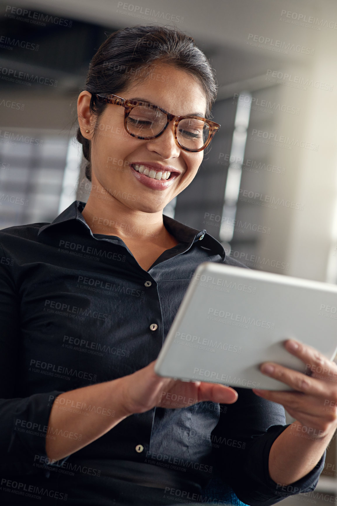 Buy stock photo Shot of a businesswoman using her digital tablet in an office