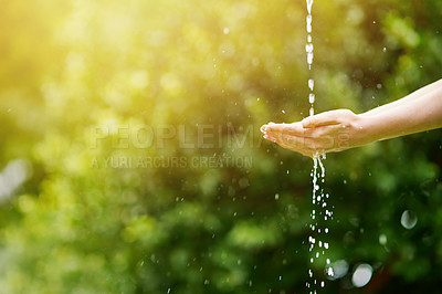 Buy stock photo Shot of hands held out under a stream of water