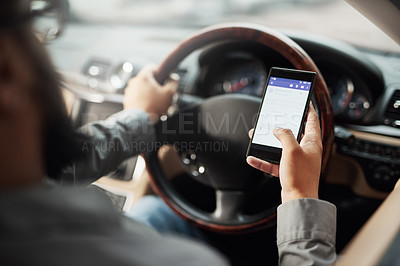 Buy stock photo Shot of a man using his phone while driving
