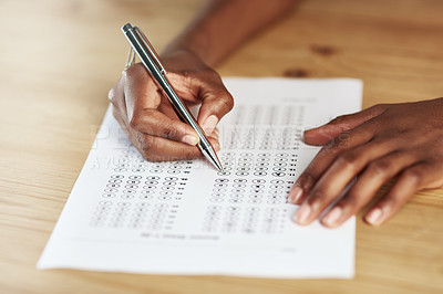Buy stock photo Shot of a person filling in an answer sheet for a test
