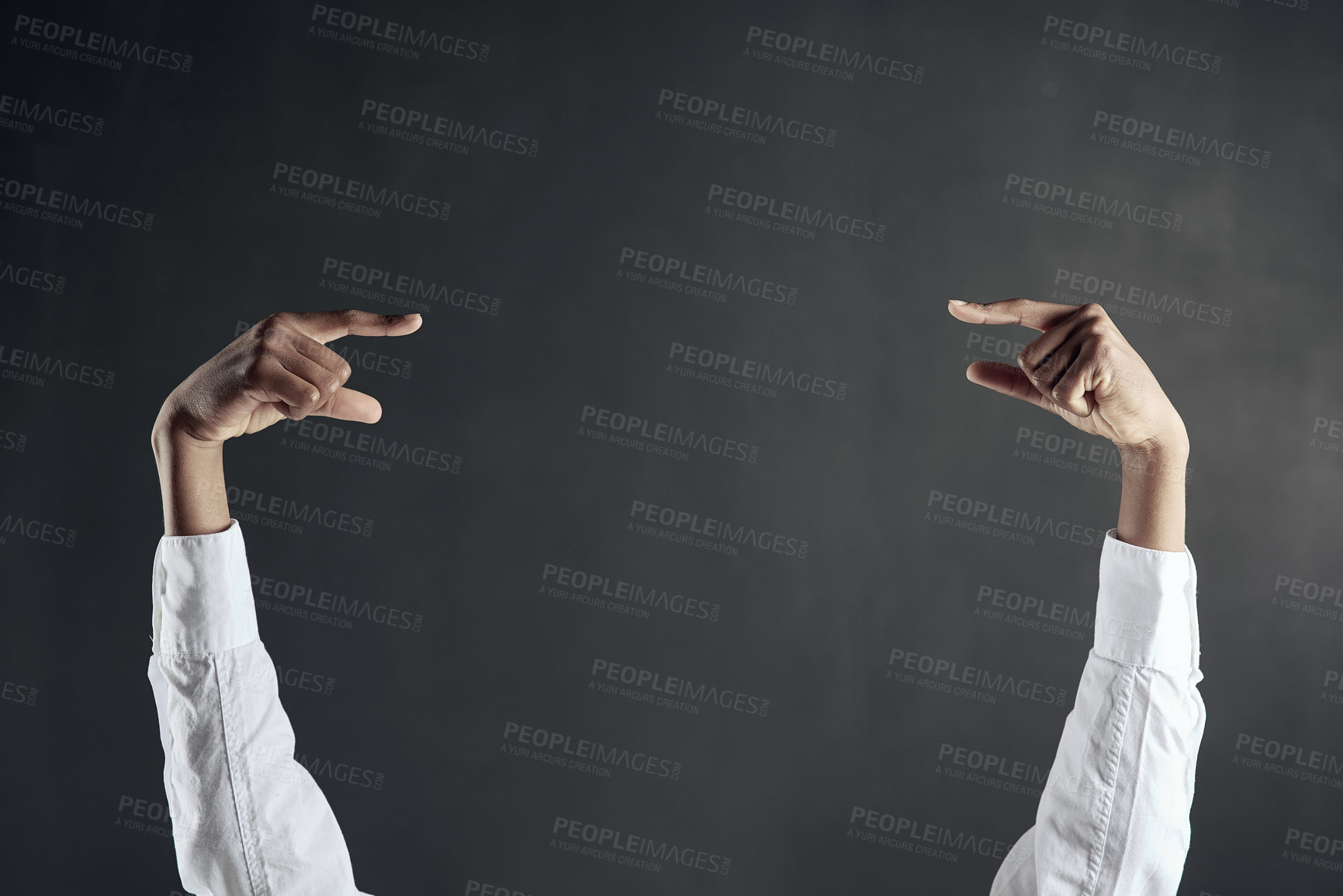 Buy stock photo Shot of hands pointing to each other against a dark background