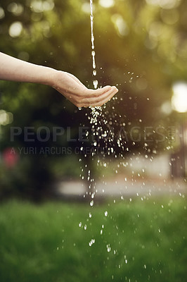 Buy stock photo Cropped shot of water running on a woman's hand outside