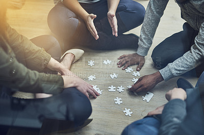 Buy stock photo Hands, business people and puzzle in circle, solution and teamwork for problem solving, planning and games. Group, together and innovation with support, synergy and team building on office floor