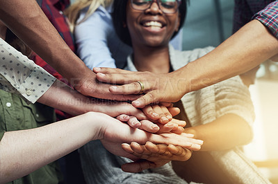Buy stock photo Shot of a group of people putting their hands together