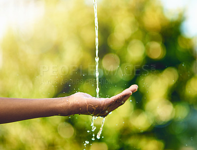 Buy stock photo Shot of hands held out to catch a stream of water outside
