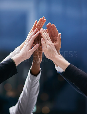 Buy stock photo Shot of a group of colleagues giving each other a high five in an office