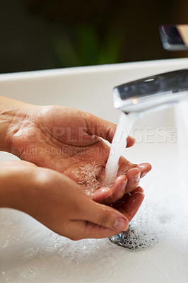 Buy stock photo Water, splash and person washing hands in house for cleaning, safety and hygiene at home. Sink, liquid and palm for prevention of dirt, bacteria or germs in bathroom with finger disinfection process