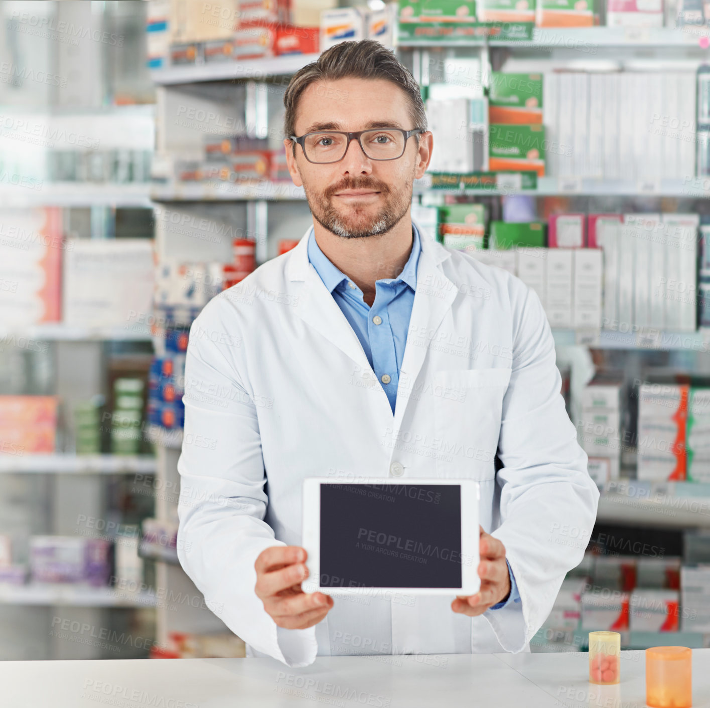 Buy stock photo Man, pharmacist and portrait with tablet screen for telehealth, medication or pharmaceutical advertising. Male person, doctor or medical worker with technology display or mockup space at dispensary