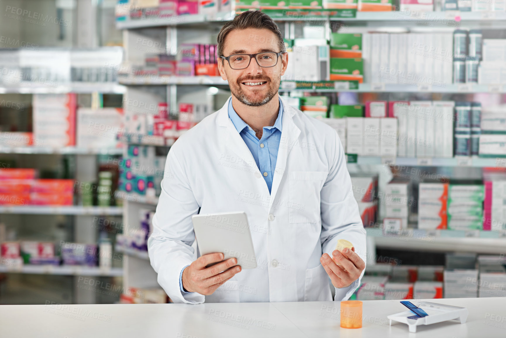 Buy stock photo Portrait, tablet and healthcare with a pharmacist man at work in a pharmacy for pharmaceutical medication. Medicine, trust and pills with a male working in a medical dispensary for treatment or cure