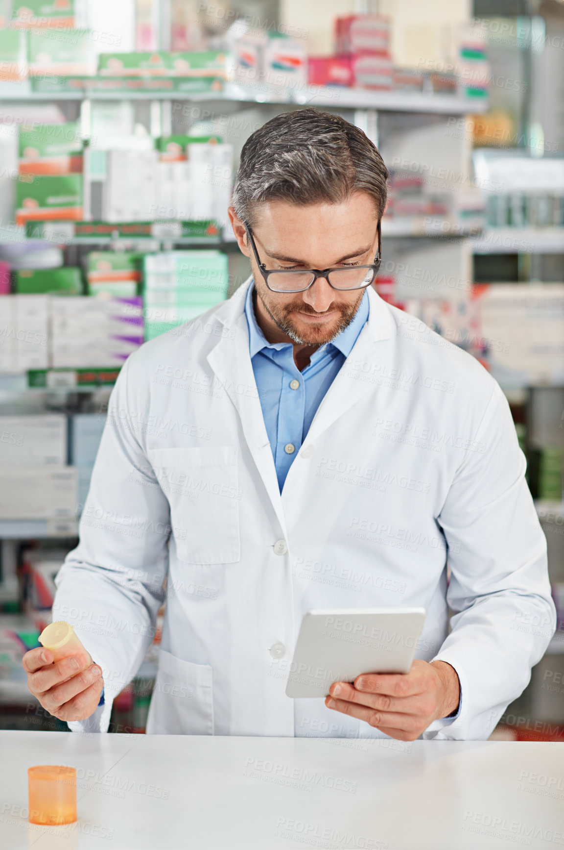 Buy stock photo Pharmacist man, store and reading with tablet, focus and medicine for marketing, pills or sales. Medical professional, pharma expert and mobile digital tech in pharmacy for wellness, health and care