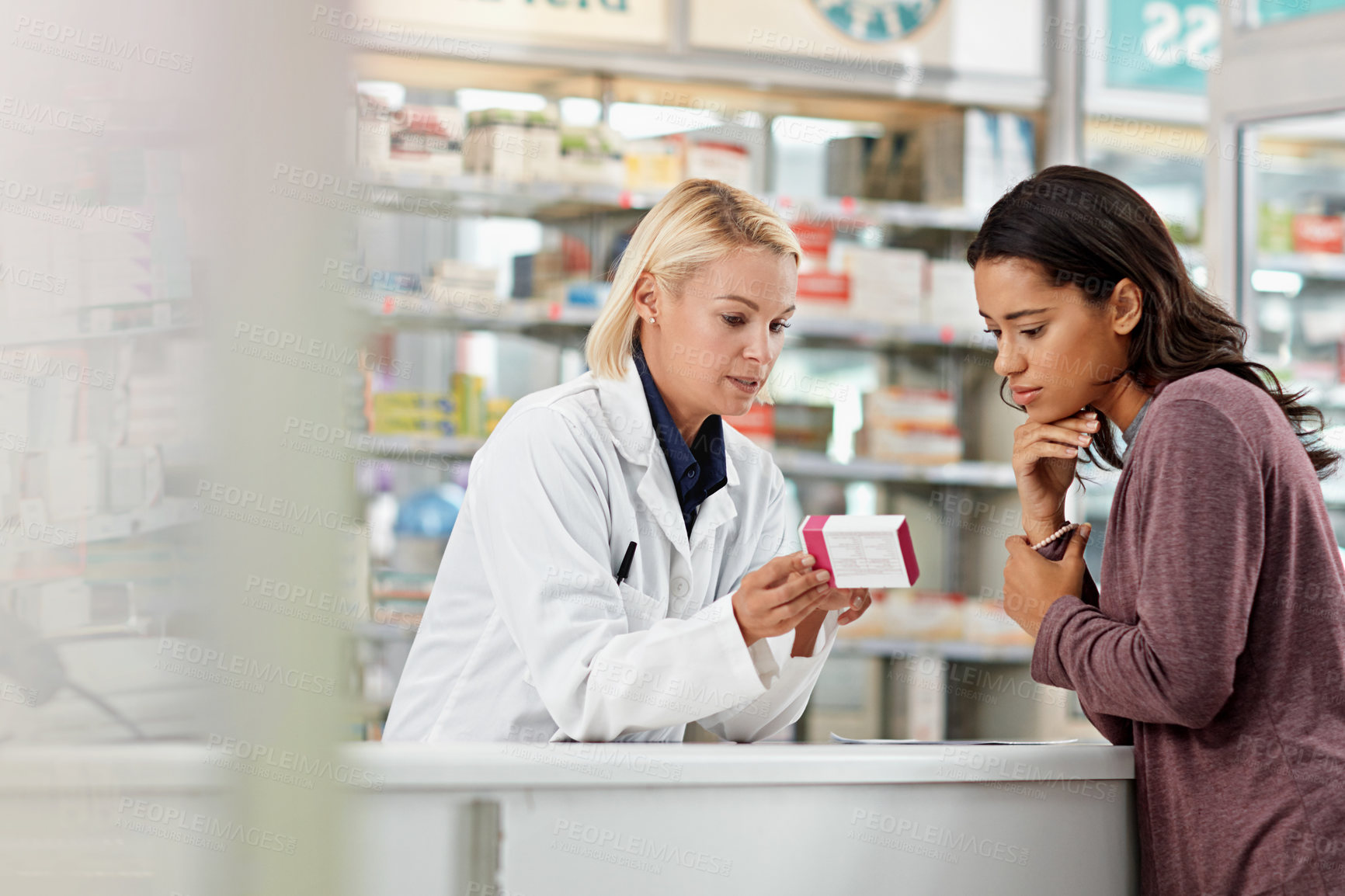 Buy stock photo Consulting customer and focus of store pharmacist at counter for expert help and customer service. Pharmaceutical advice and opinion of worker helping girl with medicine information at pharmacy.