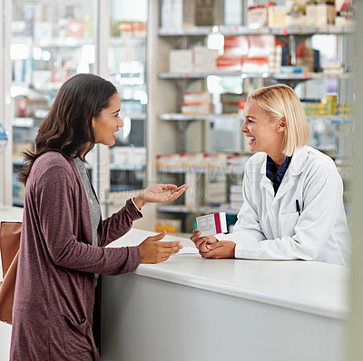Buy stock photo Shot of a pharmacist assisting a customer at the prescription counter. All products have been altered to be void of copyright infringements