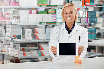 Buy stock photo Shot of a pharmacist holding up a digital tablet. All products have been altered to be void of copyright infringements