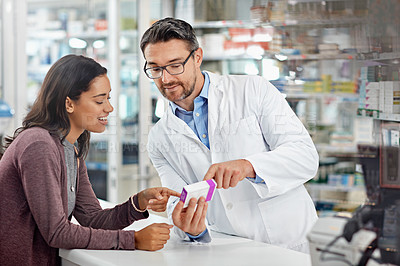 Buy stock photo Healthcare service and pharmacy worker with customer at store counter for medication explanation. Pharmaceutical advice and opinion of pharmacist helping girl with medicine information.