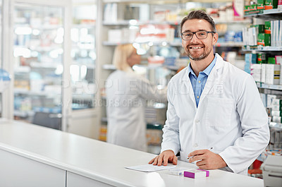 Buy stock photo Portrait of happy pharmacist man with pharmacy services, medicine advice and product trust at shop, retail counter. Inventory, stock help desk and medical professional worker, person or doctor smile