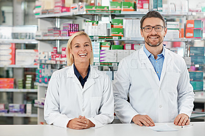 Buy stock photo Shot of two pharmacists working in a drugstore. All products have been altered to be void of copyright infringements