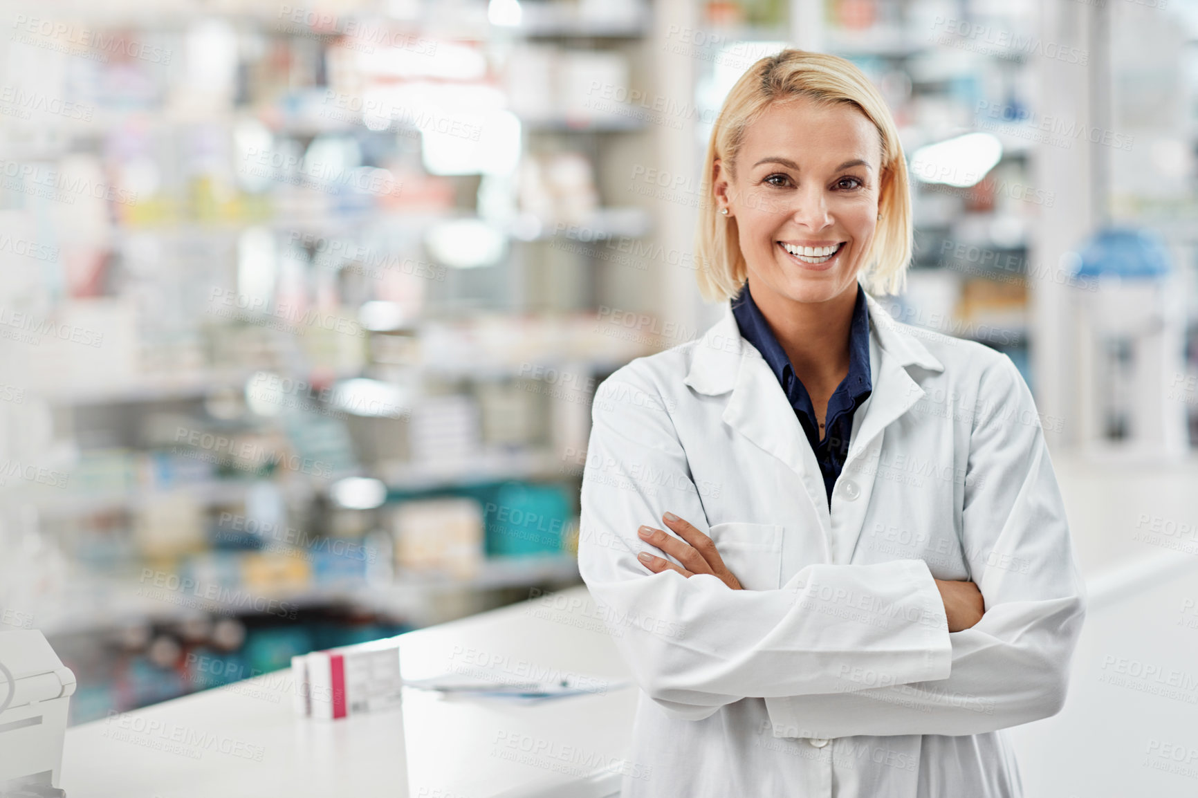 Buy stock photo Portrait of a pharmacist standing with her arms crossed in a drugstore. All products have been altered to be void of copyright infringements