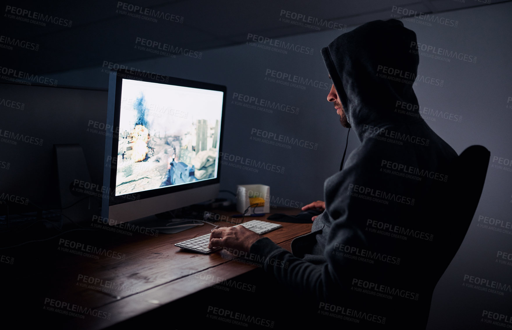 Buy stock photo Shot of a young man playing computer games at night