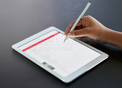 Buy stock photo Shot of a businesswoman using a stylus on a digital tablet