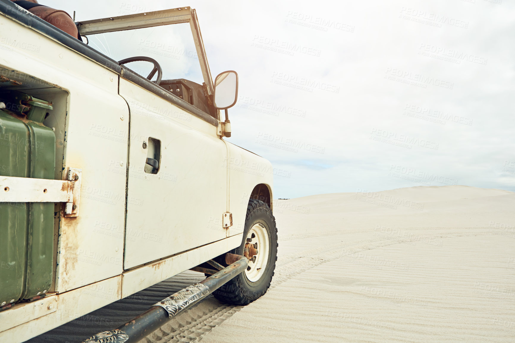 Buy stock photo Shot of a heavy duty 4x4 parked on some sand dunes