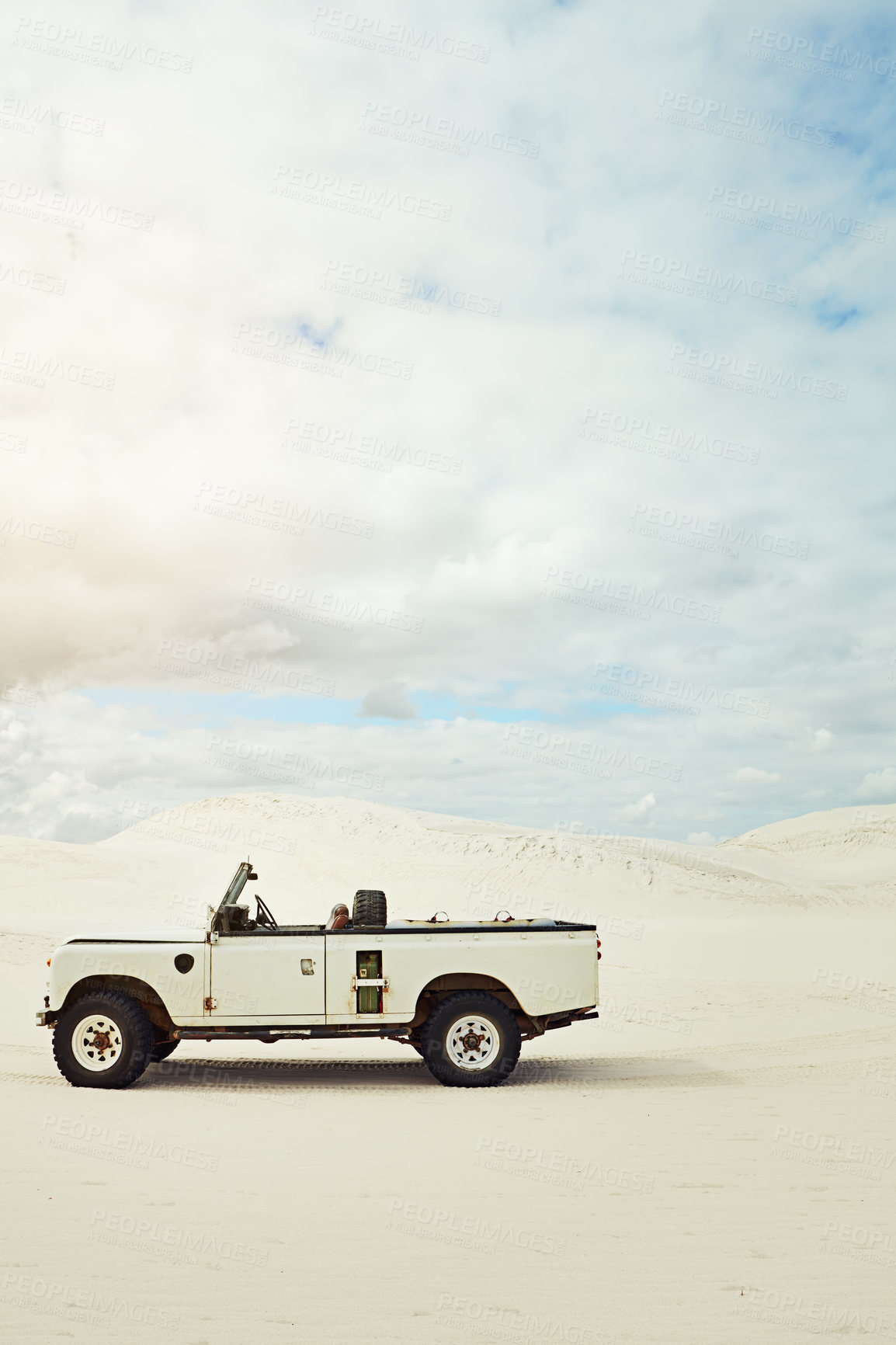 Buy stock photo Shot of a heavy duty 4x4 parked on some sand dunes