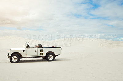 Buy stock photo Shot of a heavy duty 4x4 parked on some sand dunes