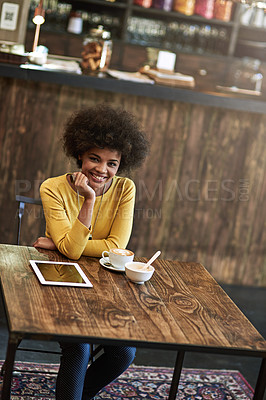 Buy stock photo Portrait of a young woman using a digital tablet in a cafe