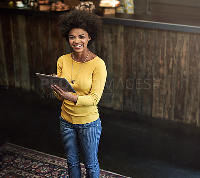Buy stock photo Portrait of a young woman using a digital tablet in a cafe