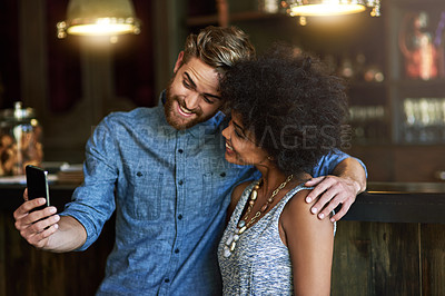 Buy stock photo Shot of two people taking a selfie in a cafe