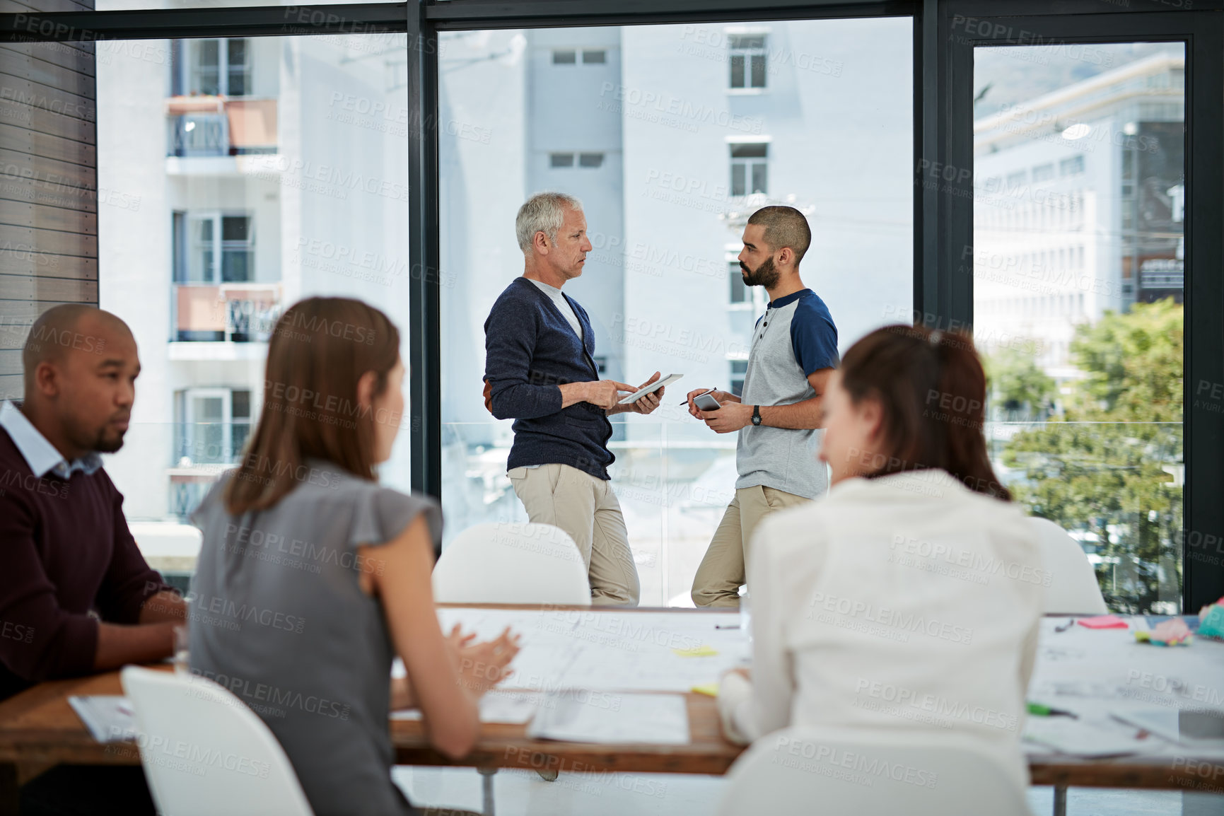 Buy stock photo Shot of colleagues having an informal office meeting