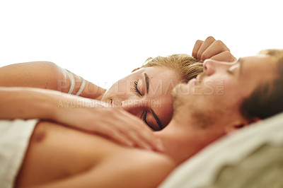 Buy stock photo Shot of a young couple asleep in bed at home