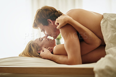 Buy stock photo Love, kiss and couple in bedroom, hug and happiness with passion, romance and loving together. Romantic, man or woman with care, bed or embrace with joy, intimate or bonding with a happy relationship