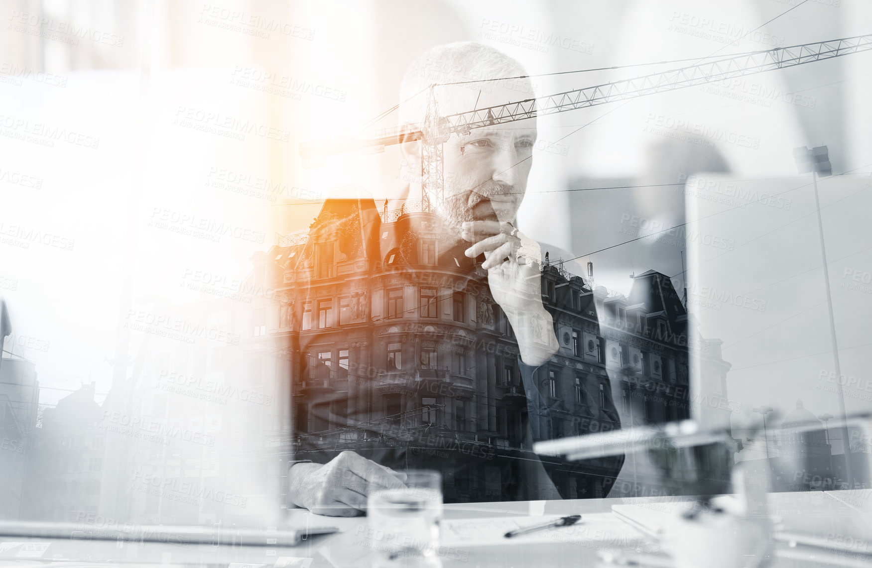 Buy stock photo Multiple exposure shot of a mature businessman using a laptop superimposed on a cityscape