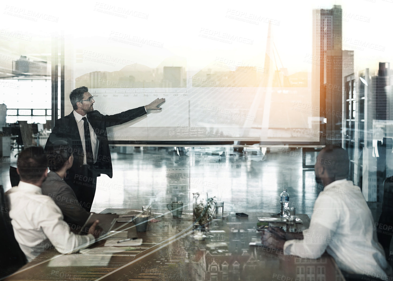 Buy stock photo Multiple exposure shot of businesspeople in a meeting superimposed on a cityscape
