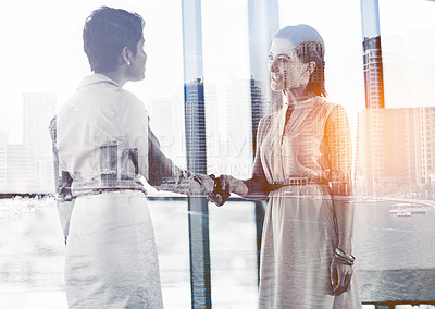 Buy stock photo Multiple exposure shot of two businesswomen shaking hands superimposed on a cityscape