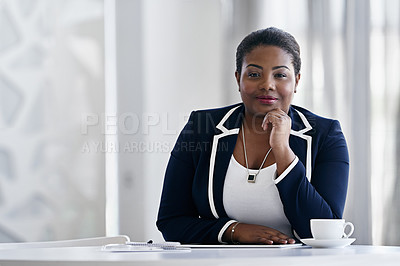 Buy stock photo Portrait of a young businesswoman sitting with a coffee at her desk in an office