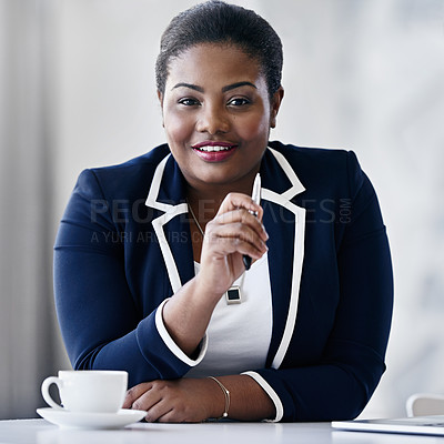Buy stock photo Portrait of a smiling young businesswoman sitting at a desk in an office