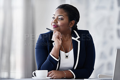 Buy stock photo Shot of a thoughtful young businesspeople working at her desk in an office