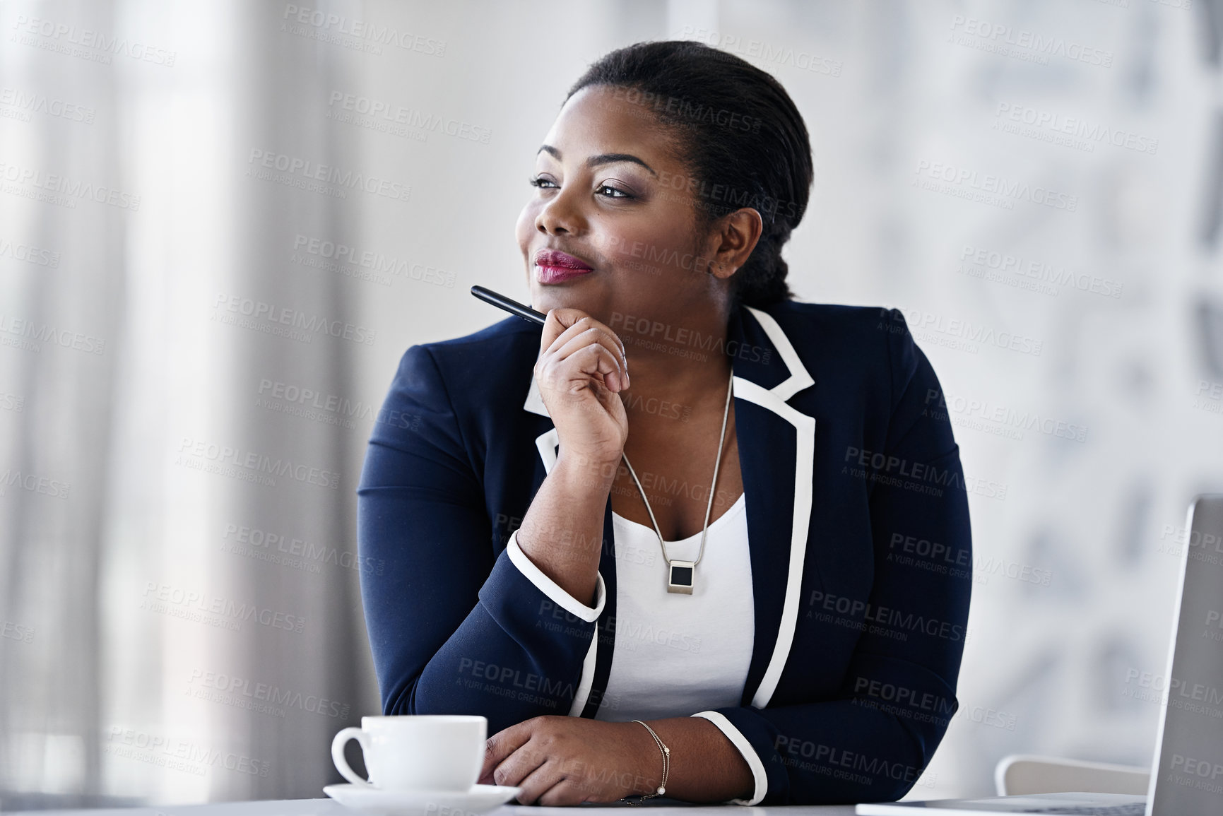 Buy stock photo Shot of a thoughtful young businesspeople working at her desk in an office