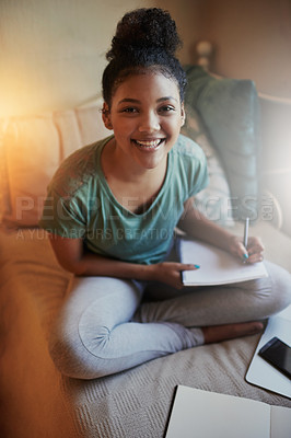 Buy stock photo High angle portrait of a young female student studying at home