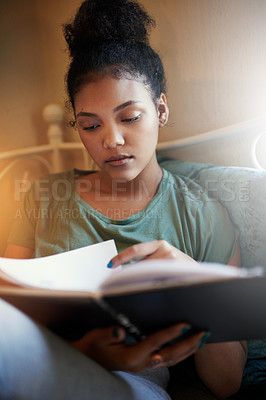 Buy stock photo Cropped shot of a young female student studying at home