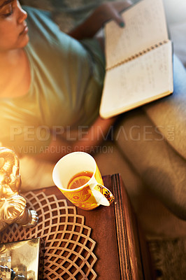 Buy stock photo High angle shot of a young female student studying at home
